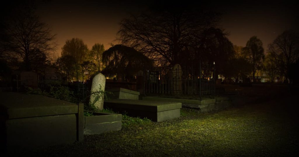 Creepy graveyard at night